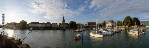 Lindau, panoramic view over the harbor into the city with shops, houses and cafes