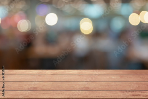 Empty wooden table top or counter on light blur bokeh glowing bright defocused lights template mock up display montages product. Wood table plank Christmas lights for products display background