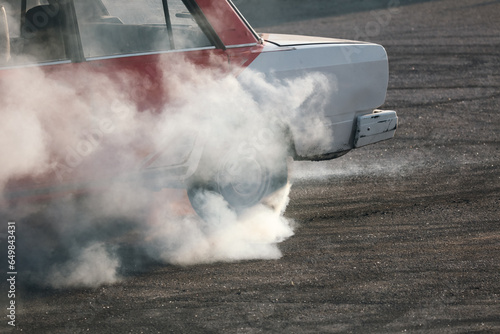Smoke from under the wheel of a car