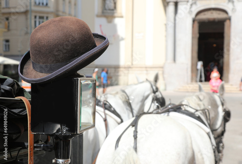 bowler hat of the coachman who takes tourists around the European city in his carriage photo