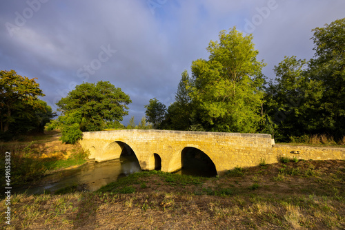 Romanesque bridge of Artigue and river Osse near Larressingle on route to Santiago de Compostela, UNESCO World Heritage Site, departement Gers, France photo