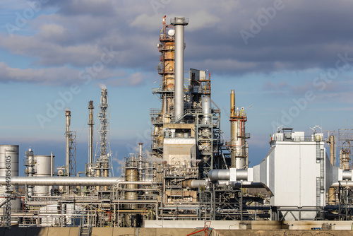 Industrial refinery complex with lots of pipes and smokestacks