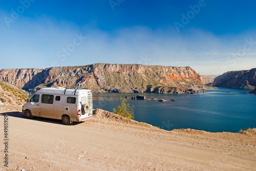 A Camper Van Parked Beside The Lake In CaÃ²on Del Atuel; San Rafael, Mendoza, Argentina photo