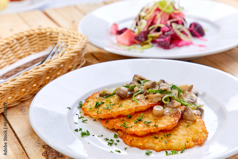 potato pancakes with sauce and mushrooms