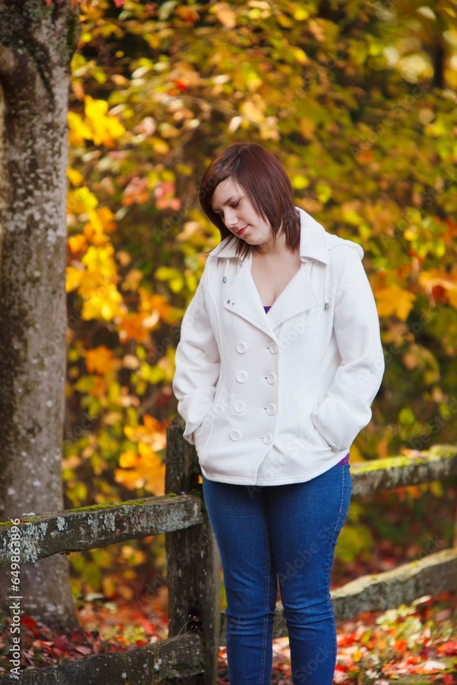 A Girl Walking Along A Trail In Autumn; Portland, Oregon, United States Of America A Girl Walking Along A Trail In Autumn; Portland, Oregon, United States Of America