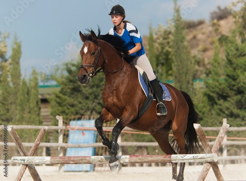 A Horse Does Jumps With A Female Rider; Benalamadena Costa, Malaga, Costa Del Sol, Andalusia, Spain