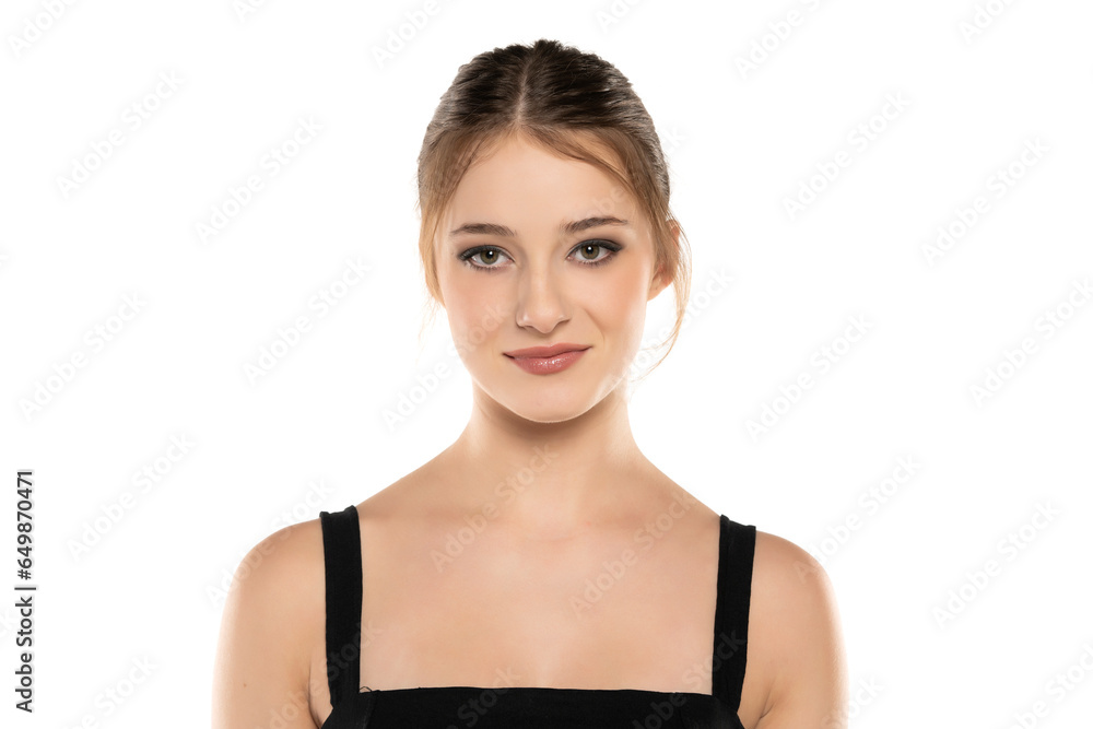 Radiant Elegance: Portrait of a Smiling Young Woman with Makeup, Updo, and Eye Contact on White Background Radiant Elegance: Portrait of a Smiling Young Woman with Makeup, Updo, and Eye Contact on White Background