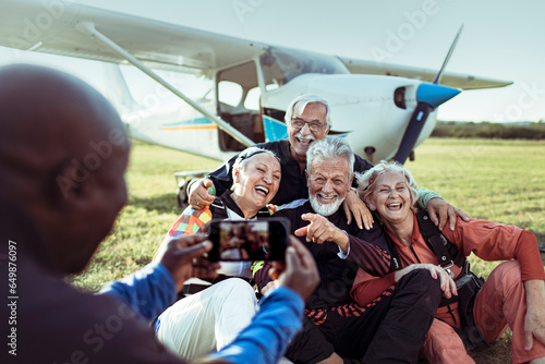 Group of senior friends taking a selfie after skydiving for the first time and completing their bucket list photo