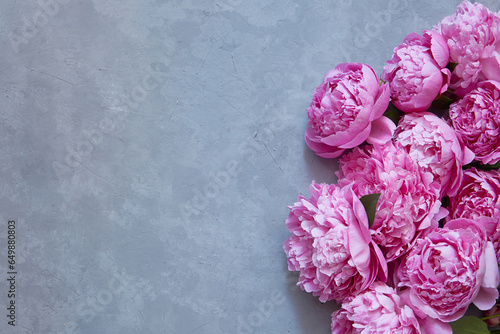 bouquet of pink peonies on a concrete gray background with a copy space for congratulations on birthday, Valentine's day, mother's day. photo