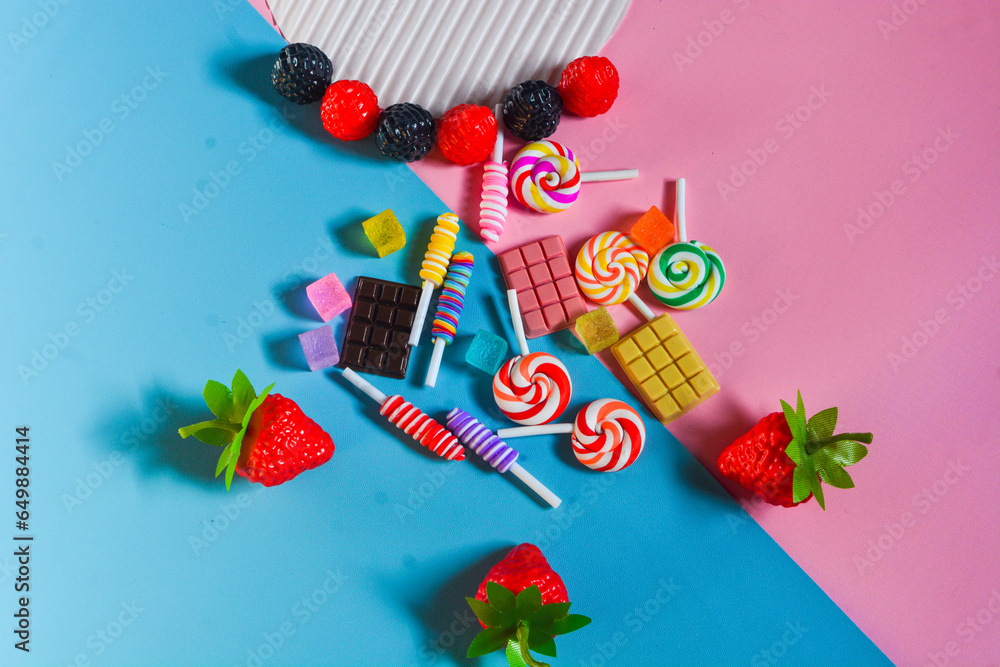 Flat lay close up sweet snack with assorted blueberries, blackberries, strawberries, chocolate, cotton candy, candies