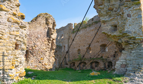 Toolse fortress which used to belong to teutonic order and crusaders of holy roman empire. Old fort in ruins - lots of cracks and cables holding it up. Medieval castle in Estonia photo