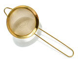 Golden strainer for bulk products on a white isolated background, top view