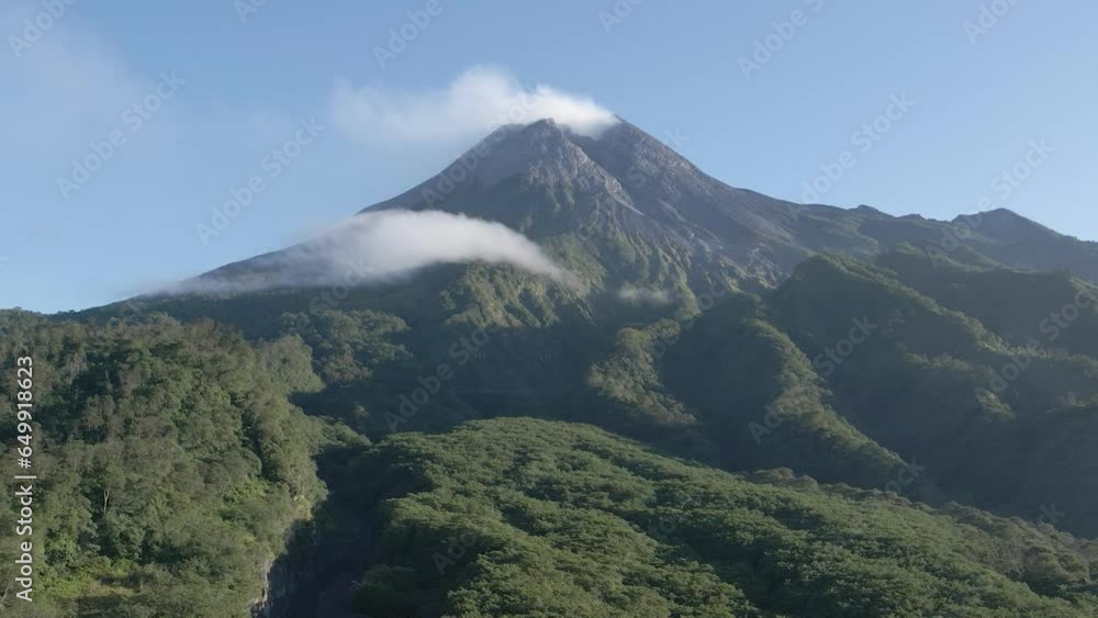 Stunning aerial view of Mount Merapi, a beautiful and peaceful active volcano. Beautiful wild natural views around the mountain in the form of dense forests, valleys and hills Stunning aerial view of Mount Merapi, a beautiful and peaceful active volcano. Beautiful wild natural views around the mountain in the form of dense forests, valleys and hills