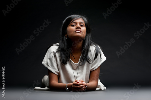 Indian lady on ground, questioning, judging gaze