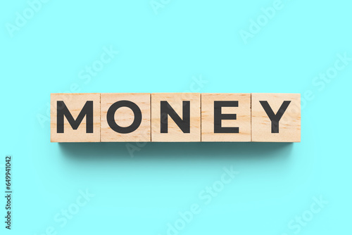 Money wooden cubes on turquoise background