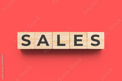 Sales wooden cubes on red background