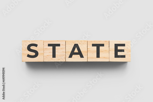 State wooden cubes on grey background