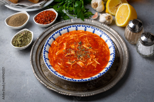 Chicken noodle soup with tomato. Turkish name; Domatesli tavuklu sehriye corbasi photo