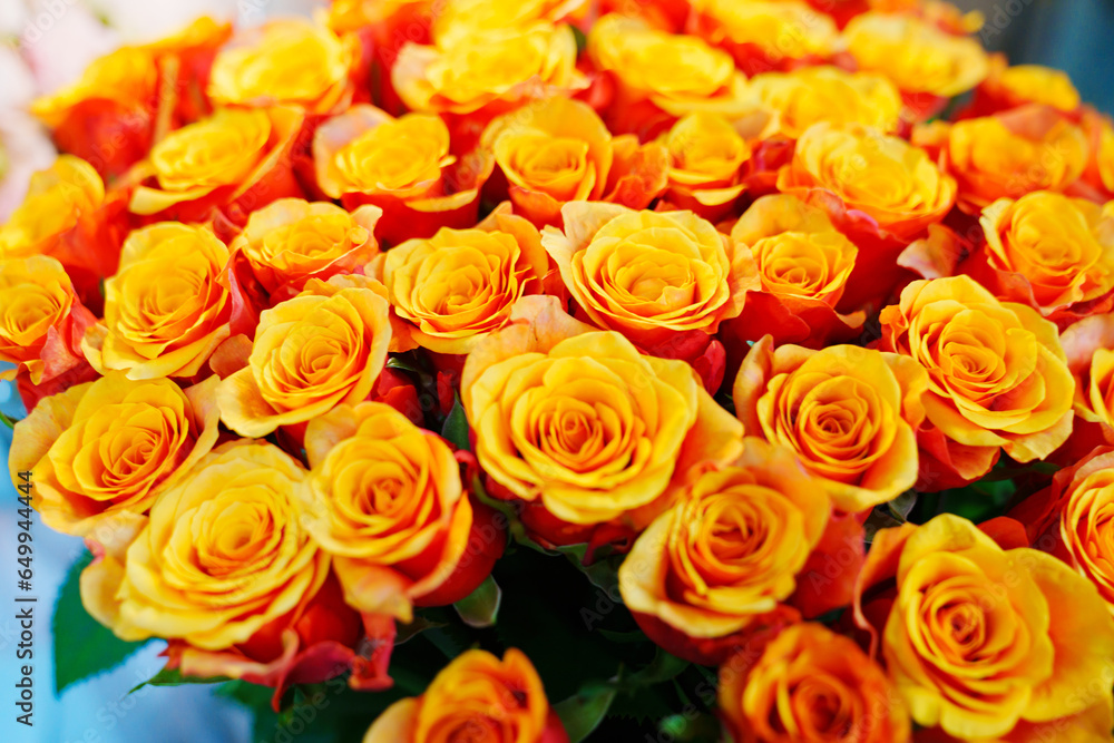 Naklejka premium Large and beautiful bouquet of orange yellow roses. 