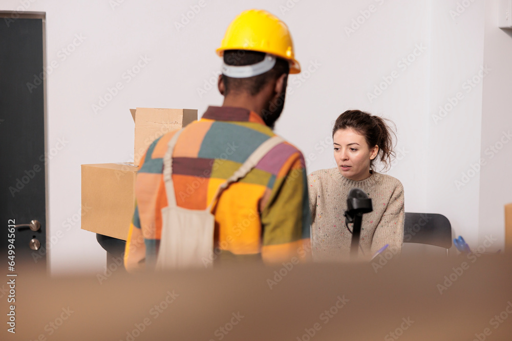 Warehouse employees discussing merchandise inventory report, working at products quality control in storehouse. Diverse team checking online orders preparing customers packages in storage room Warehouse employees discussing merchandise inventory report, working at products quality control in storehouse. Diverse team checking online orders preparing customers packages in storage room