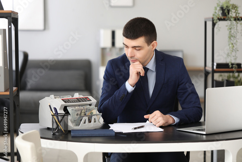 Male bank manager working w...