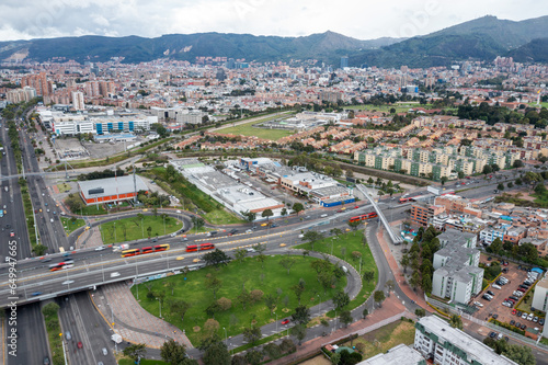 Dynamic Aerial View of Bogotá's Bustling Streets – Blurry Vehicles in Motion Under a Radiant Sun Create a Vivid Urban Tapestry