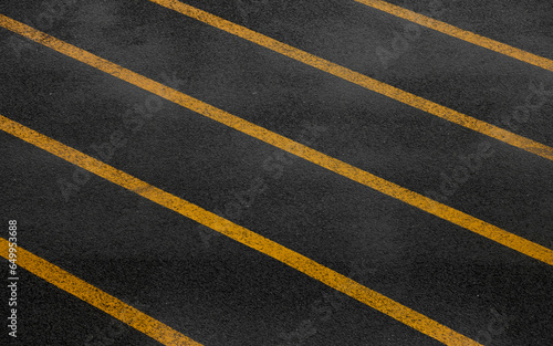 Yellow paralel lines on dark wet asphalt