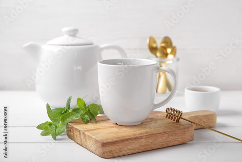 White ceramic teapot and mu...