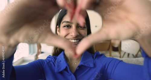 Close up portrait happy Indian woman in love showing heart symbol to camera, express sincere feelings, demonstrate gratitude, express positive feedback for services, health insurance. Donation sign