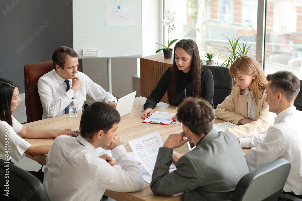 Group of business consultants working at table in office Group of business consultants working at table in office