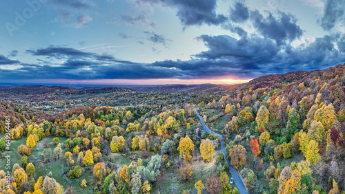 Aerial top view of the autumn forest and hills in Romania. Autumn landscape