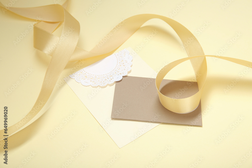 Blank card and golden ribbon on color background Blank card and golden ribbon on color background