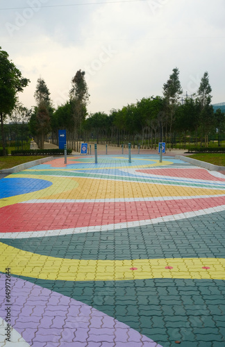 Selective focus picture of colourful crosswalk road in gloomy day.