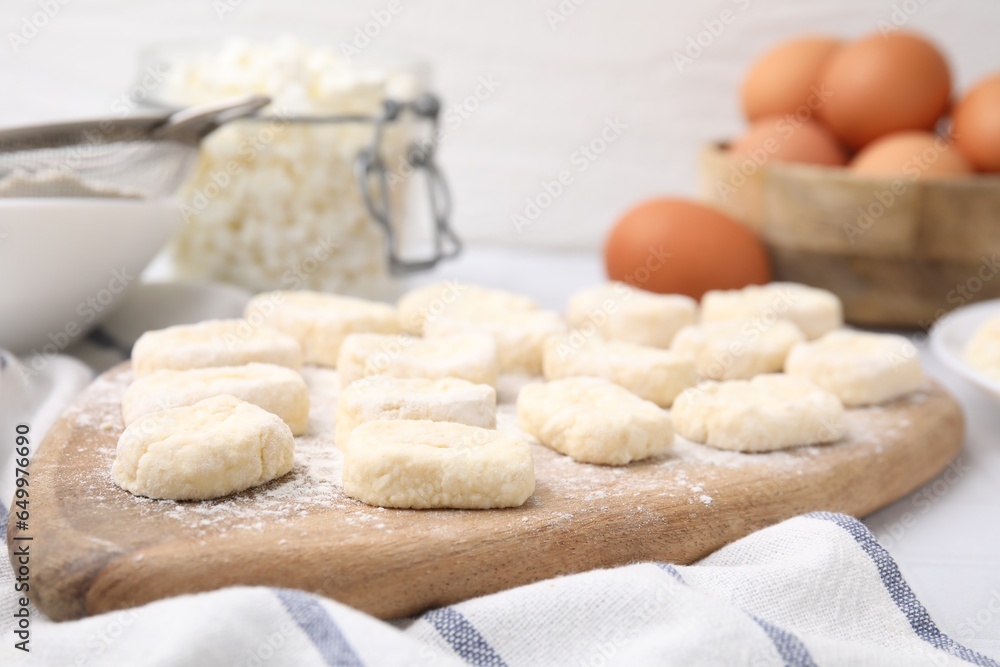 Making lazy dumplings. Wooden board with cut dough and flour on table, closeup