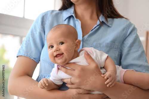 Young woman with her baby at home, closeup