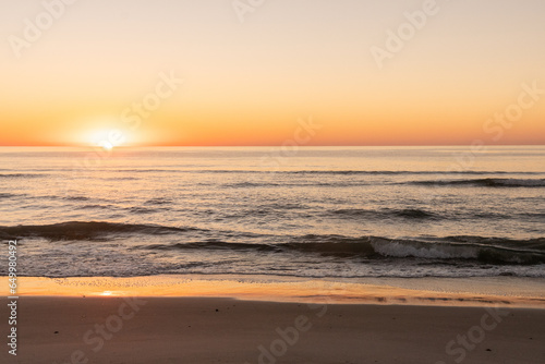 Sunrise over the Atlantic Ocean from the beach on Pawleys Island South Carolina photo