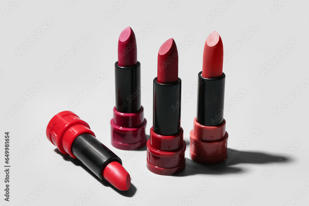 Obraz premium Different new stylish lipsticks on light background, closeup