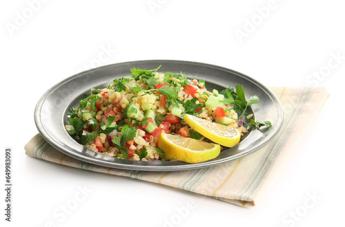 Plate with delicious tabbouleh salad and lemon slices on white background