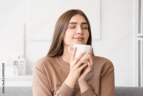 Young woman with cup of hot...