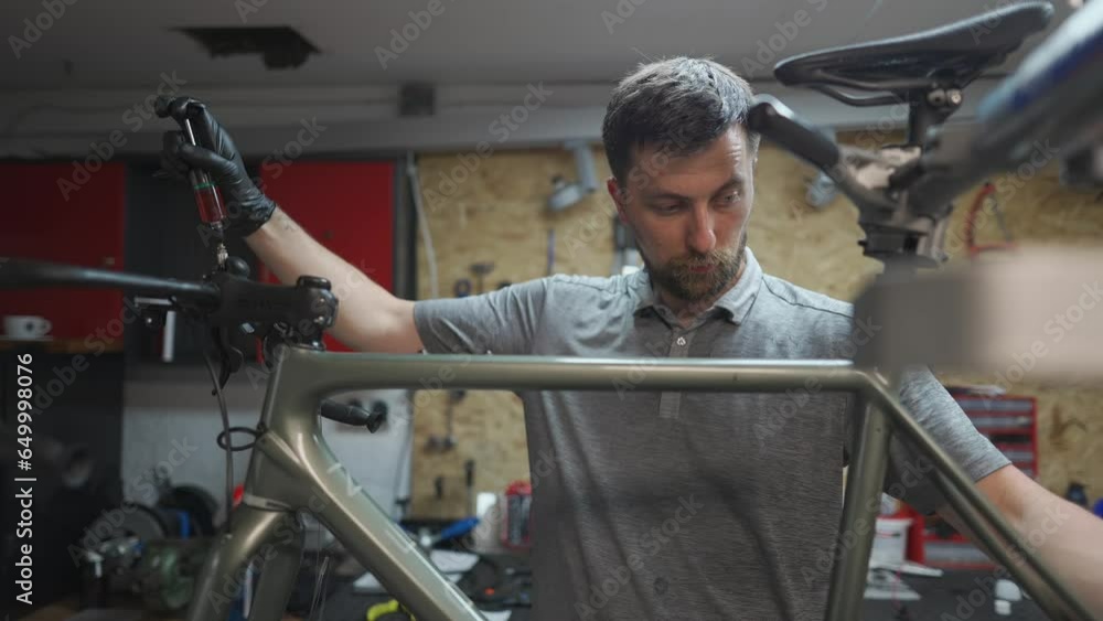 Bicycle mechanic holding syringe with brake fluid during brake bleeding