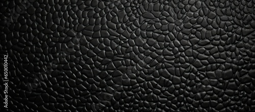Black plastic textured background zoomed in