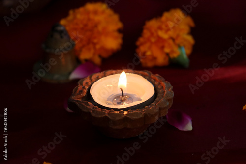 "Diwali's Illuminating Spirit: A Glowing Diya and Sunflower Celebration"