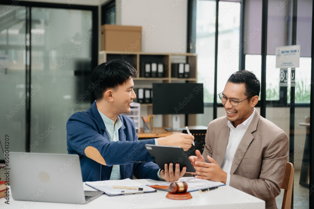 Fototapeta premium Business law concept, Lawyer business lawyers are consulting lawyers for man entrepreneurs to file copyright lawsuit with laptop and tablet at office