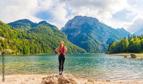 Sporty female looking at beautiful Italian mountain lake