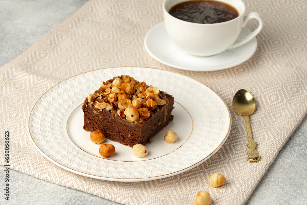 Brownie cake with nuts topping on plate close up Brownie cake with nuts topping on plate close up
