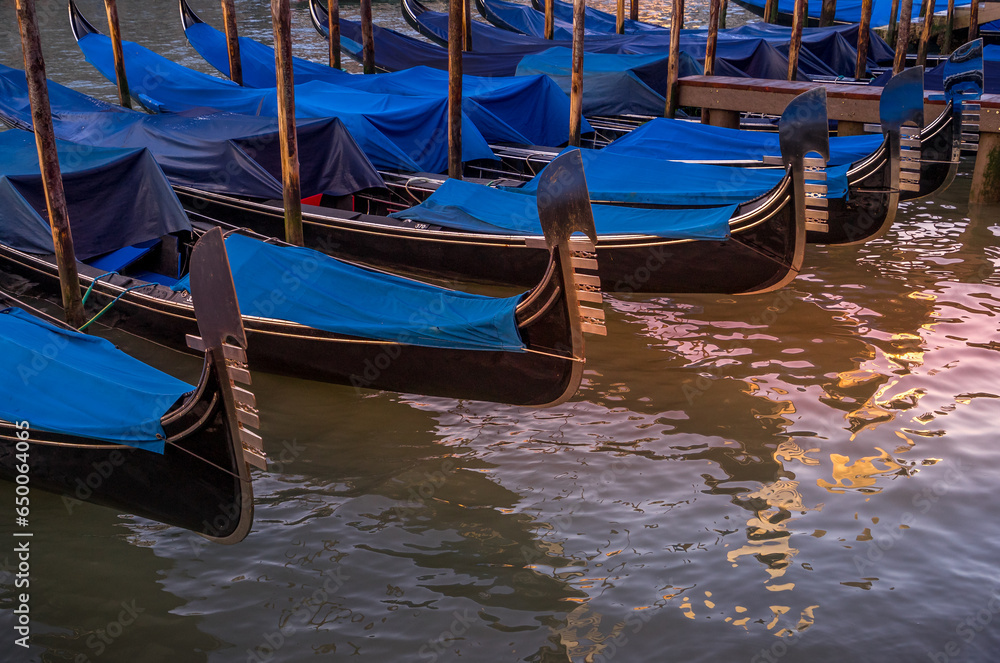 Gondolas moored at the side of the Grand Canal in Venice, Italy