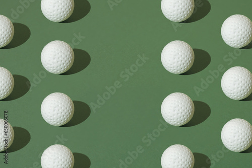 White golf ball on a green pastel background. Minimal pattern with copy space. photo