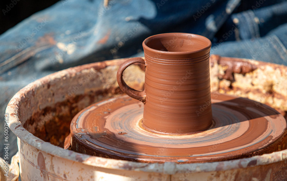 Making dishes from clay by the hands of a master, a mug, a jug. Making dishes from clay by the hands of a master, a mug, a jug.