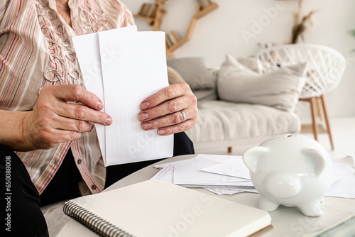 Ukrainian senior citizen concerned about electricity expenses. Managing household finances photo