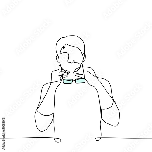 man putting on or taking off glasses - one line art vector. concept of testing glasses, glasses for vision